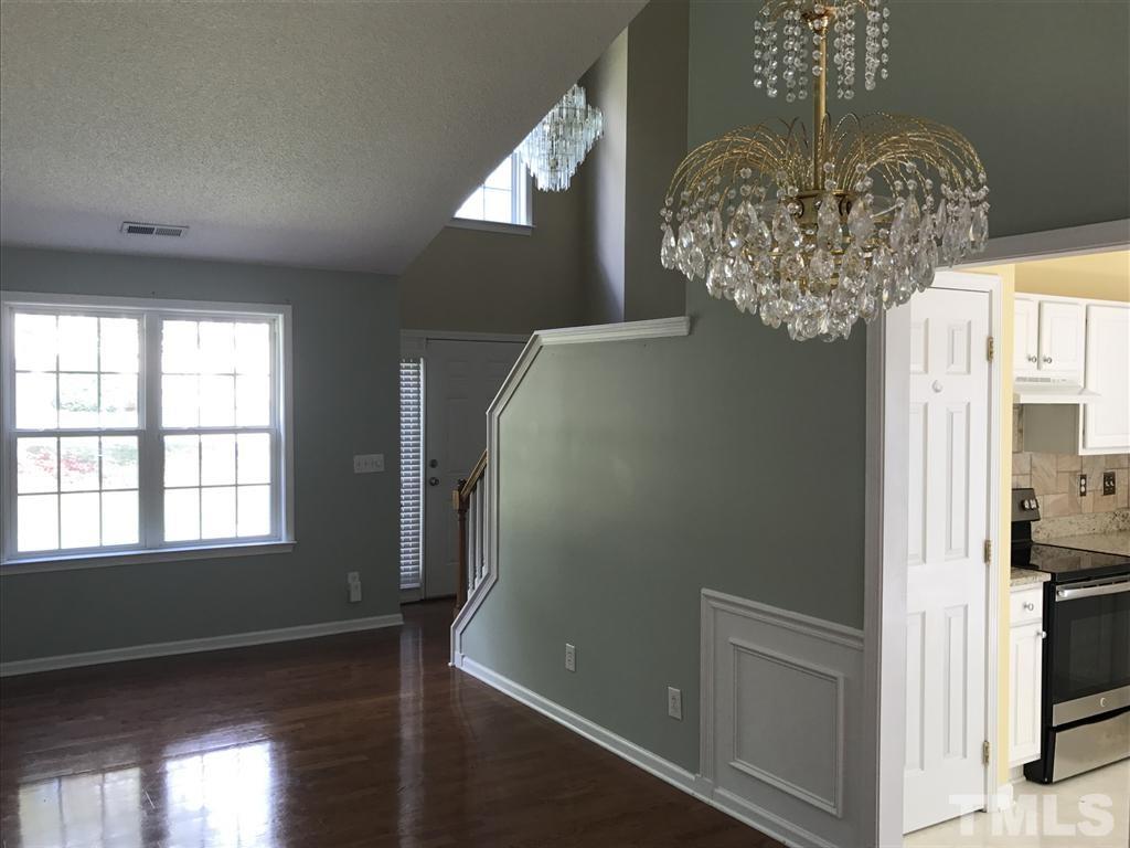 4528 Drewbridge Way Raleigh, NC 27604 - Photo 6 of 25 a view of a hallway with wooden floor and staircase