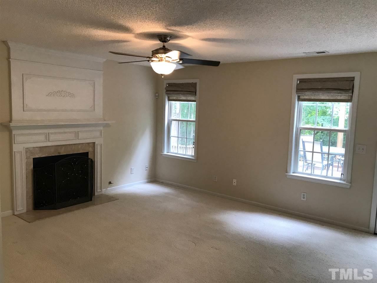 4528 Drewbridge Way Raleigh, NC 27604 - Photo 7 of 25 a view of an empty room with a fireplace