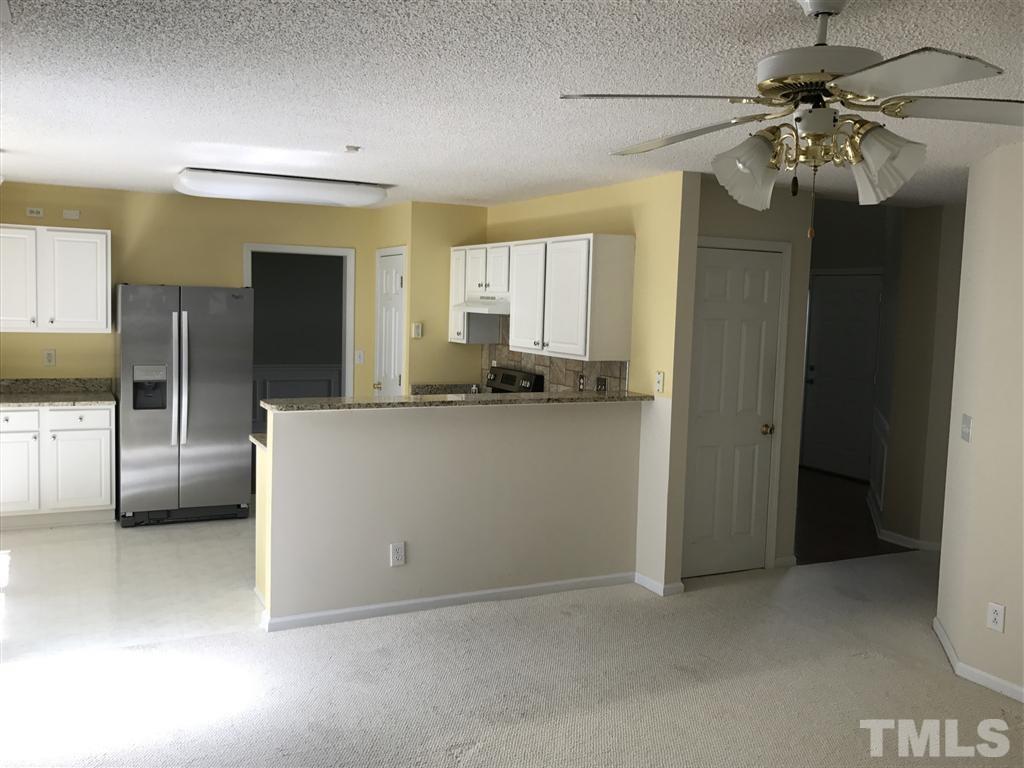 4528 Drewbridge Way Raleigh, NC 27604 - Photo 8 of 25 a kitchen with stainless steel appliances a sink a refrigerator and cabinets