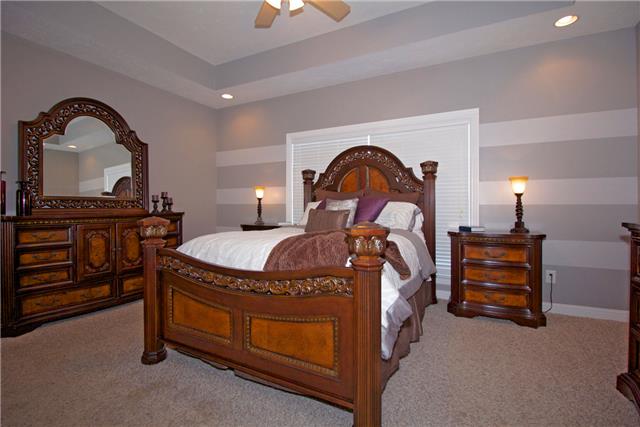 259 Aplin Branch Road Cottontown, TN 37048 - Photo 12 of 19 a bedroom with a bed and a dresser