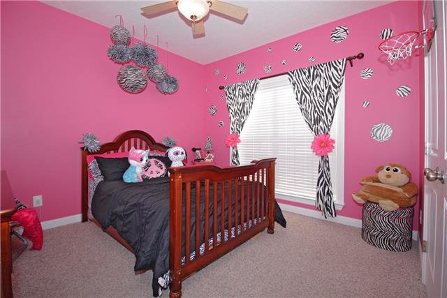 259 Aplin Branch Road Cottontown, TN 37048 - Photo 13 of 19 a bedroom with a bed and a window