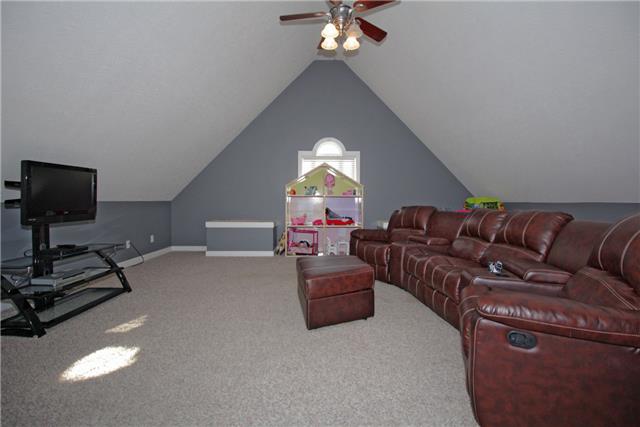 259 Aplin Branch Road Cottontown, TN 37048 - Photo 8 of 19 a living room with furniture a flat screen tv and a chandelier