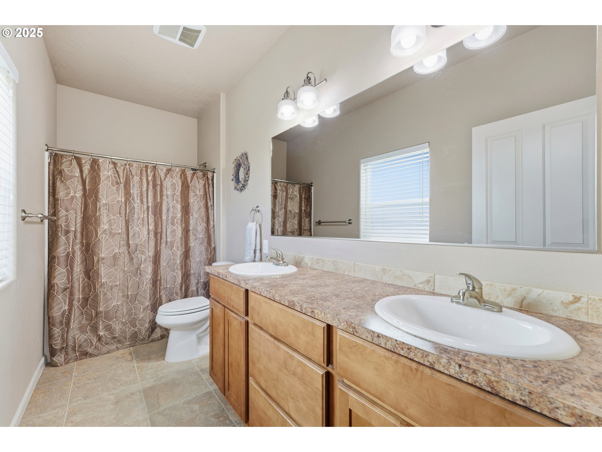 1914 Southwest 2nd Drive Pendleton, OR 97801 - Photo 21 of 35 a bathroom with a granite countertop sink toilet a mirror a vanity and a shower