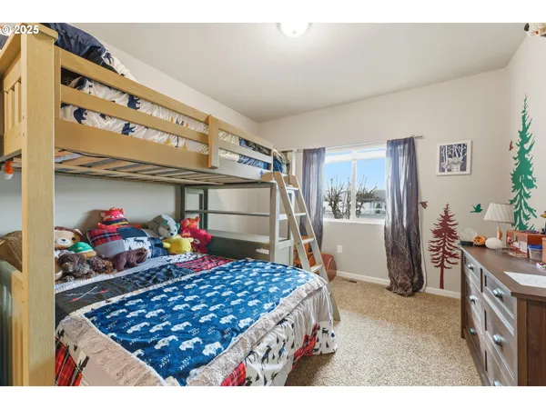 a kitchen area with stainless steel appliances a stove and a refrigerator