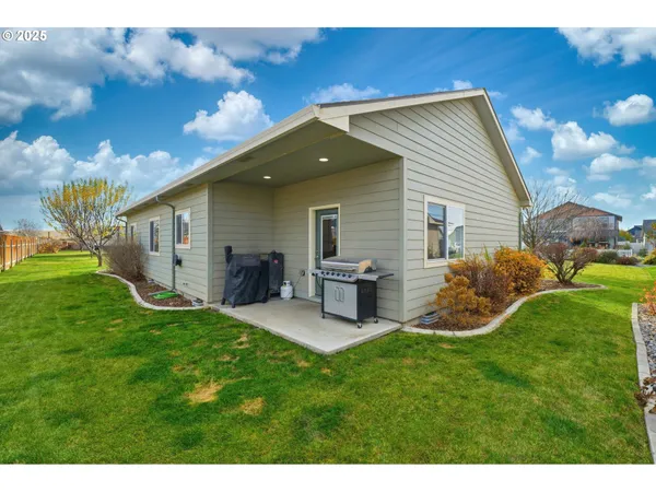 a view of a backyard with plants and a patio