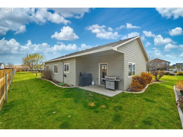 a house view with a sitting space and garden