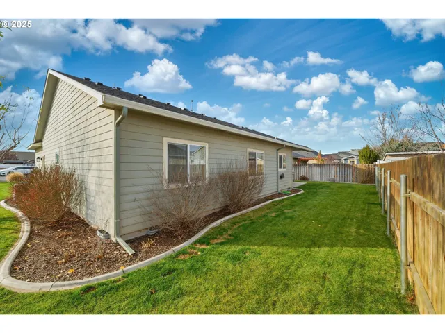 a view of a backyard with large trees