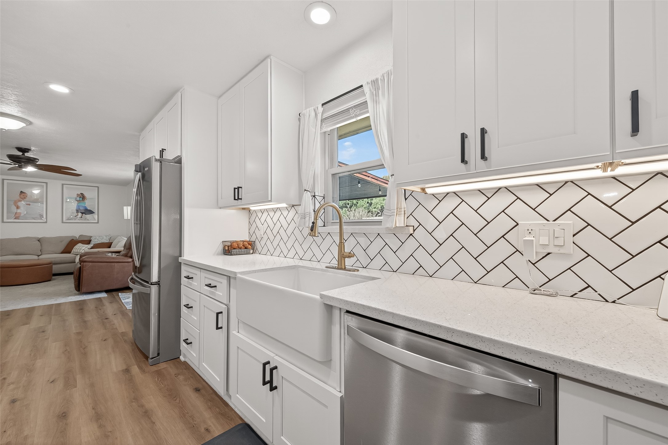 302 Jay Street Boling, TX 77420 - Photo 11 of 21 a kitchen with a sink dishwasher a refrigerator and a stove with wooden floor