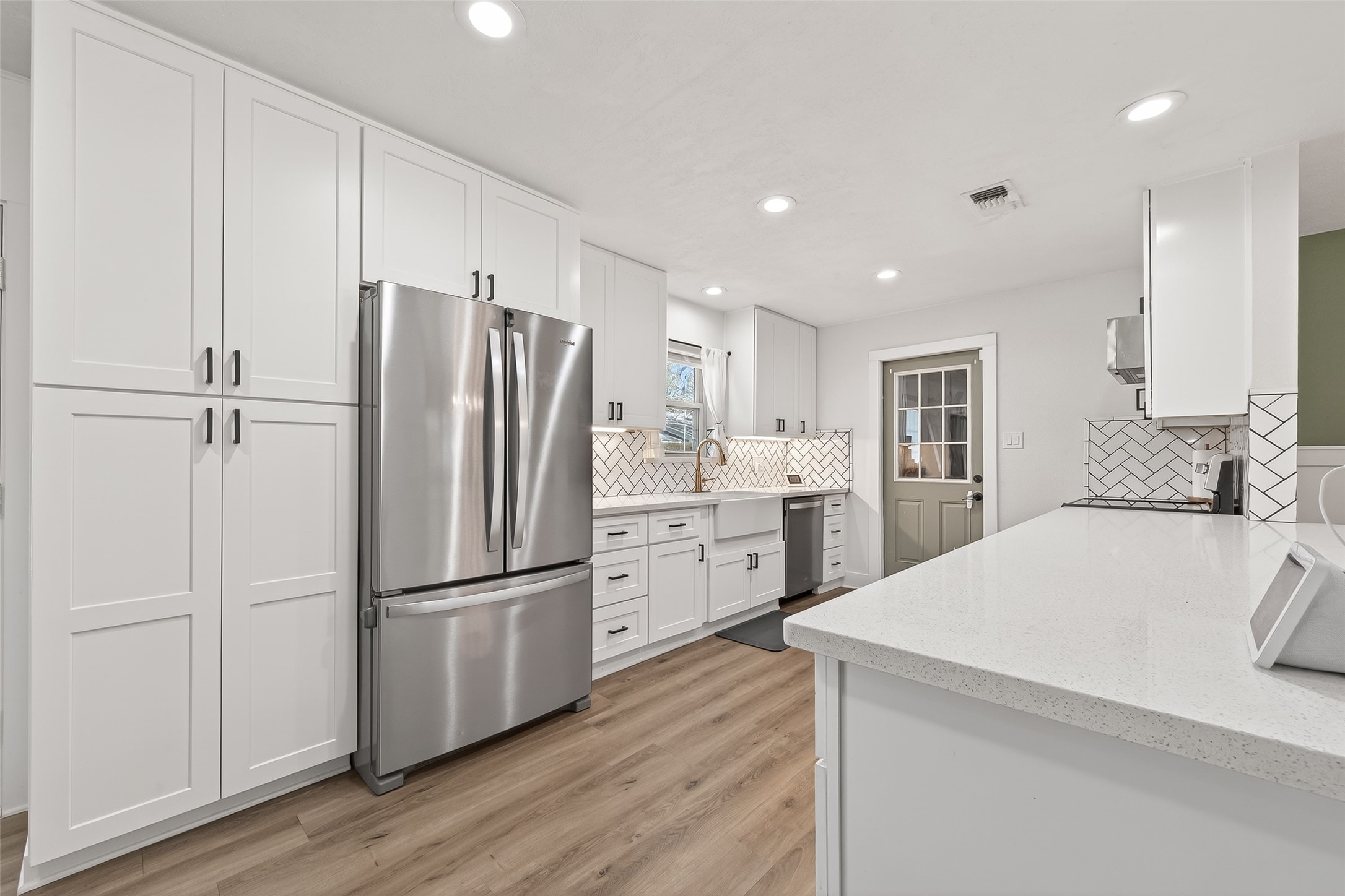 302 Jay Street Boling, TX 77420 - Photo 12 of 21 a kitchen with a refrigerator a sink and cabinets