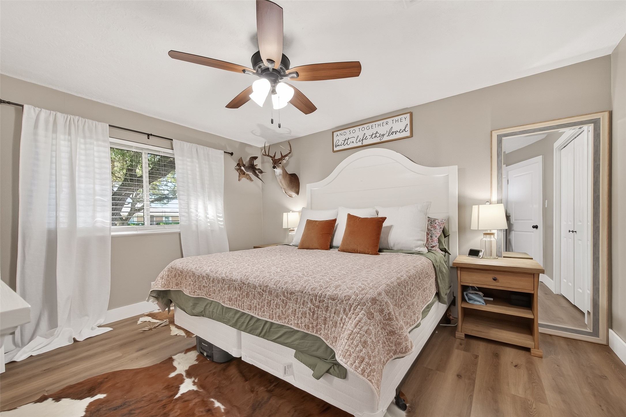 302 Jay Street Boling, TX 77420 - Photo 13 of 21 a bedroom with a bed and a chandelier