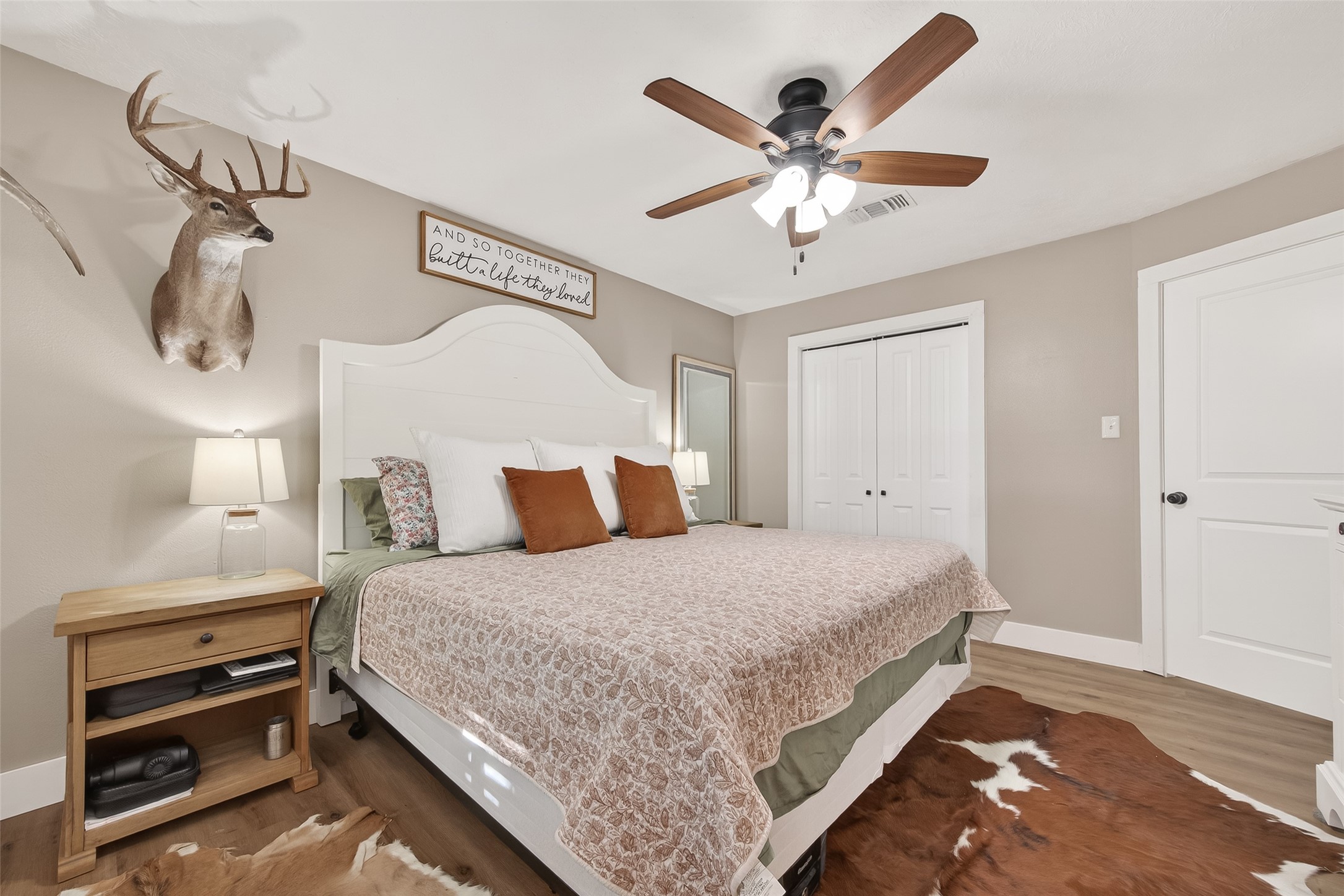 302 Jay Street Boling, TX 77420 - Photo 14 of 21 a bedroom with a large bed and a chandelier
