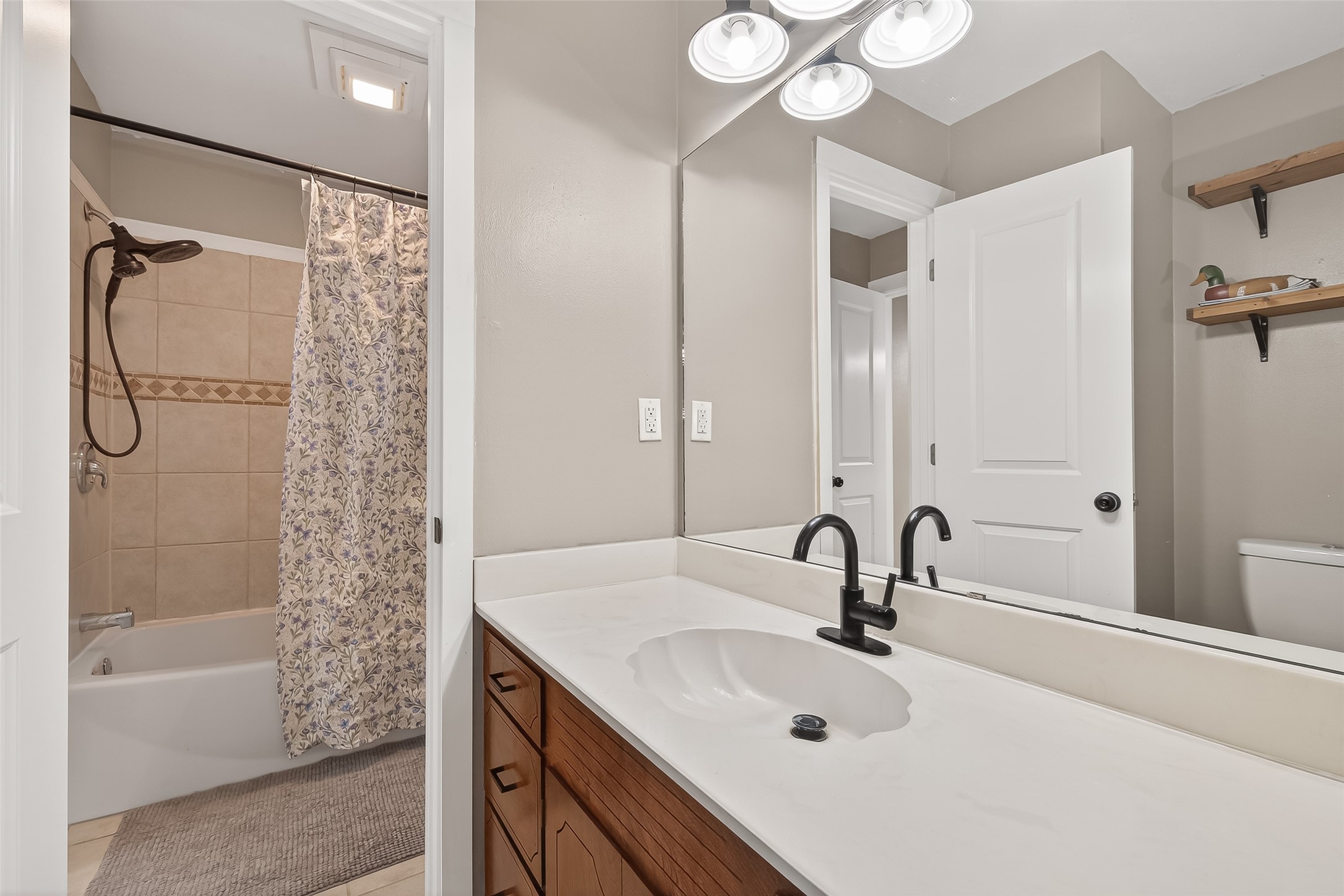 302 Jay Street Boling, TX 77420 - Photo 17 of 21 a bathroom with a sink a toilet a mirror and shower