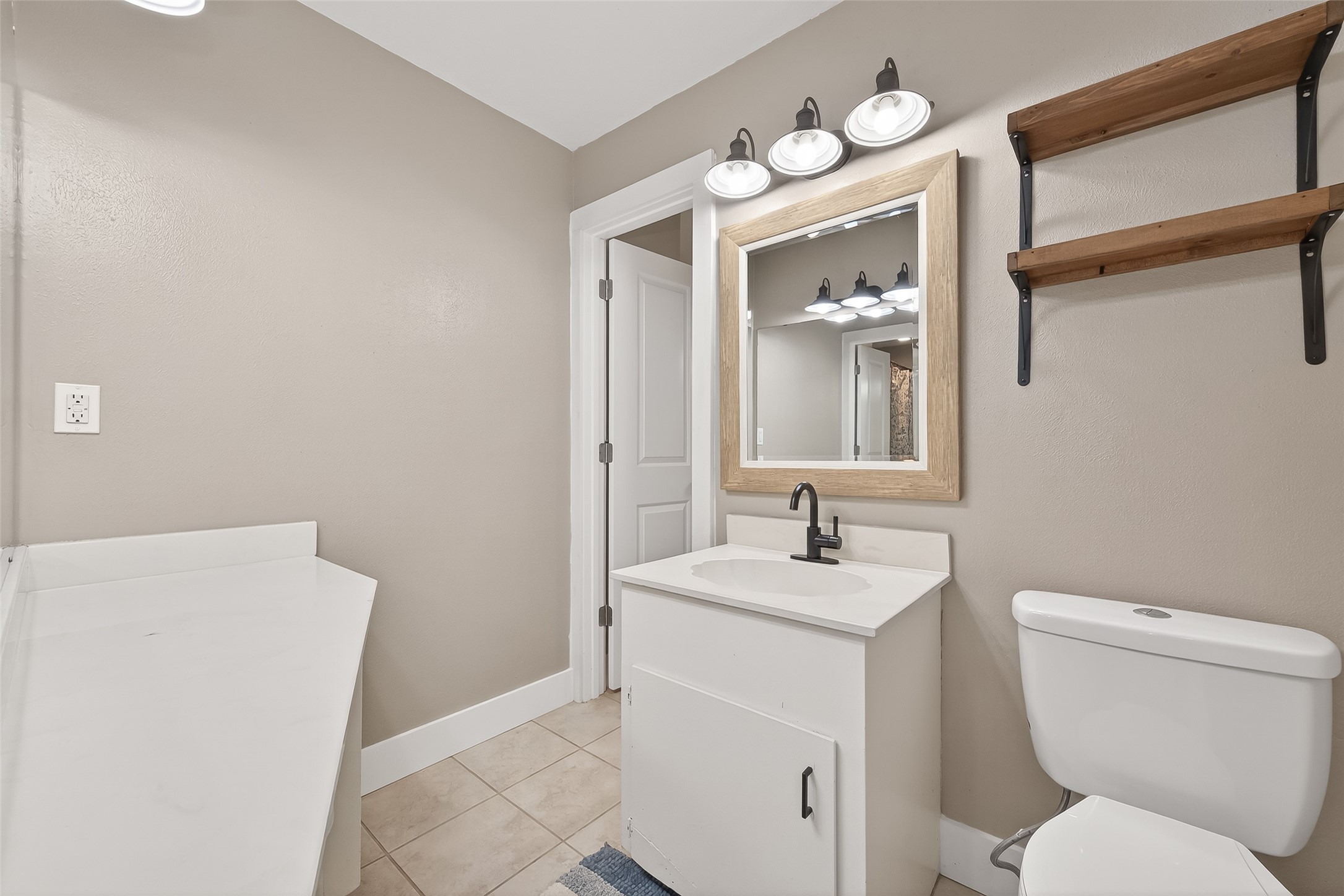 302 Jay Street Boling, TX 77420 - Photo 18 of 21 a bathroom with a toilet sink and mirror