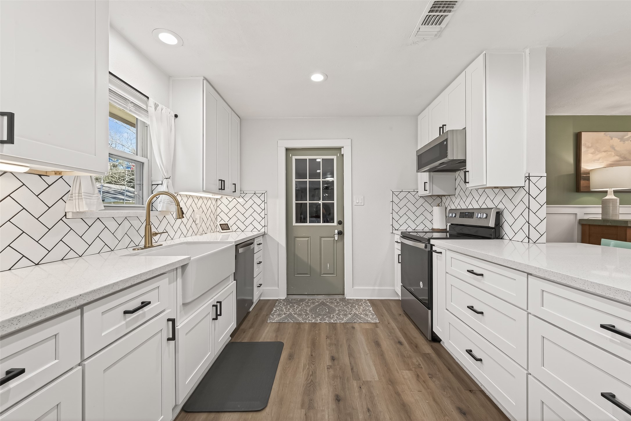 302 Jay Street Boling, TX 77420 - Photo 10 of 21 a kitchen with granite countertop white cabinets and white appliances