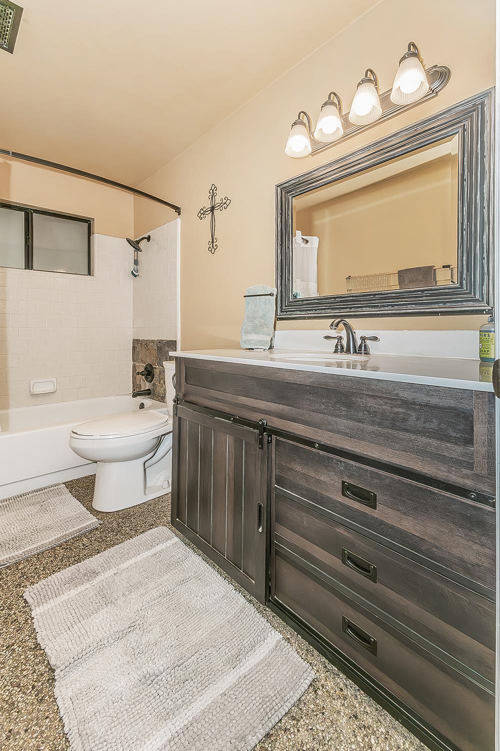 29545 Oak Meadow Road Tollhouse, CA 93667 - Photo 36 of 69 a bathroom with a double vanity sink mirror and bathtub
