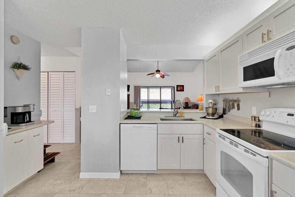 9637 Riverside Drive, Unit 3 Sebastian, FL 32958 - Photo 10 of 36 a kitchen with a sink stove and microwave