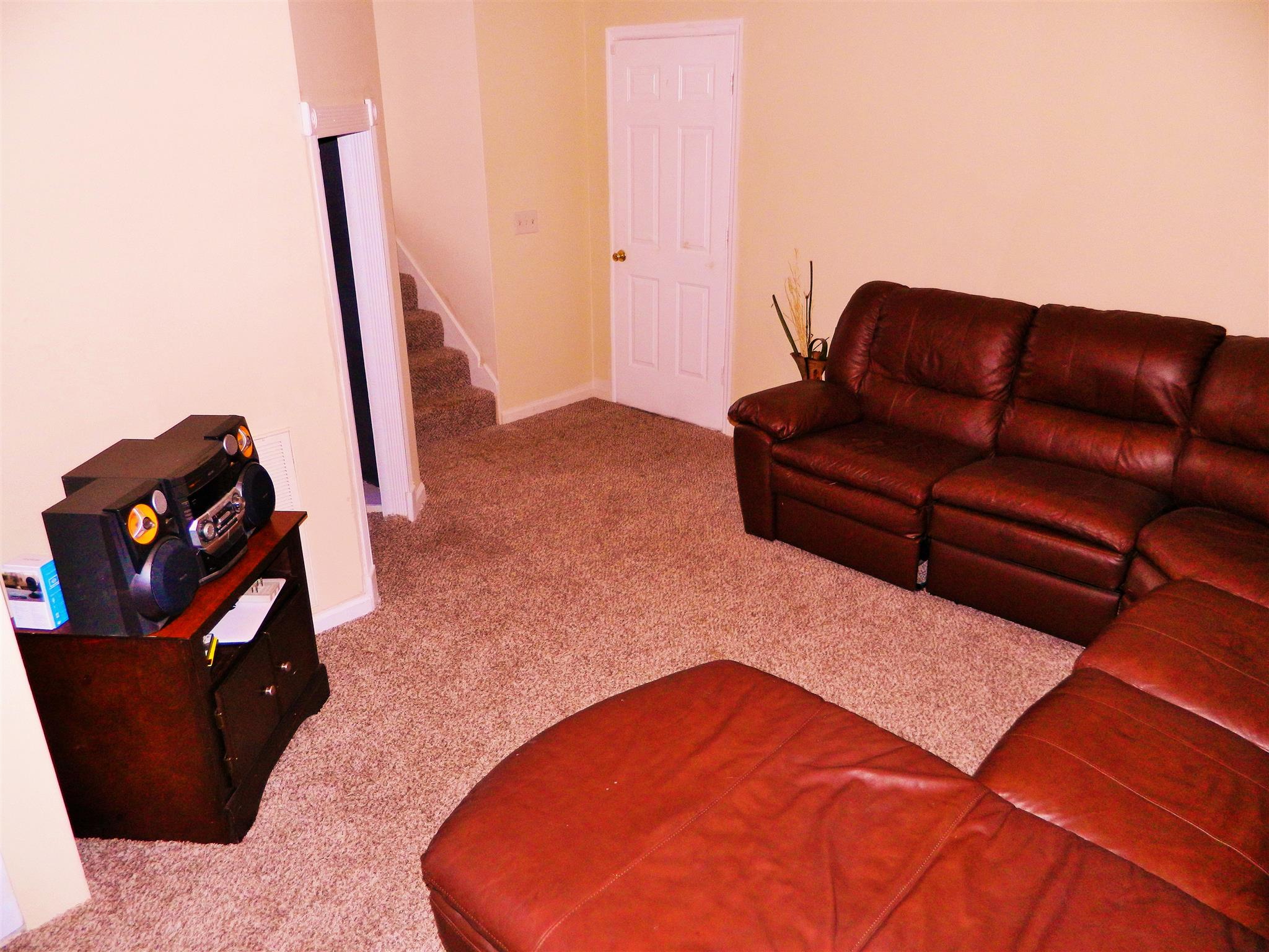881 Bishopsgate Road Antioch, TN 37013 - Photo 12 of 19 a blue couch sitting in a living room with a rug