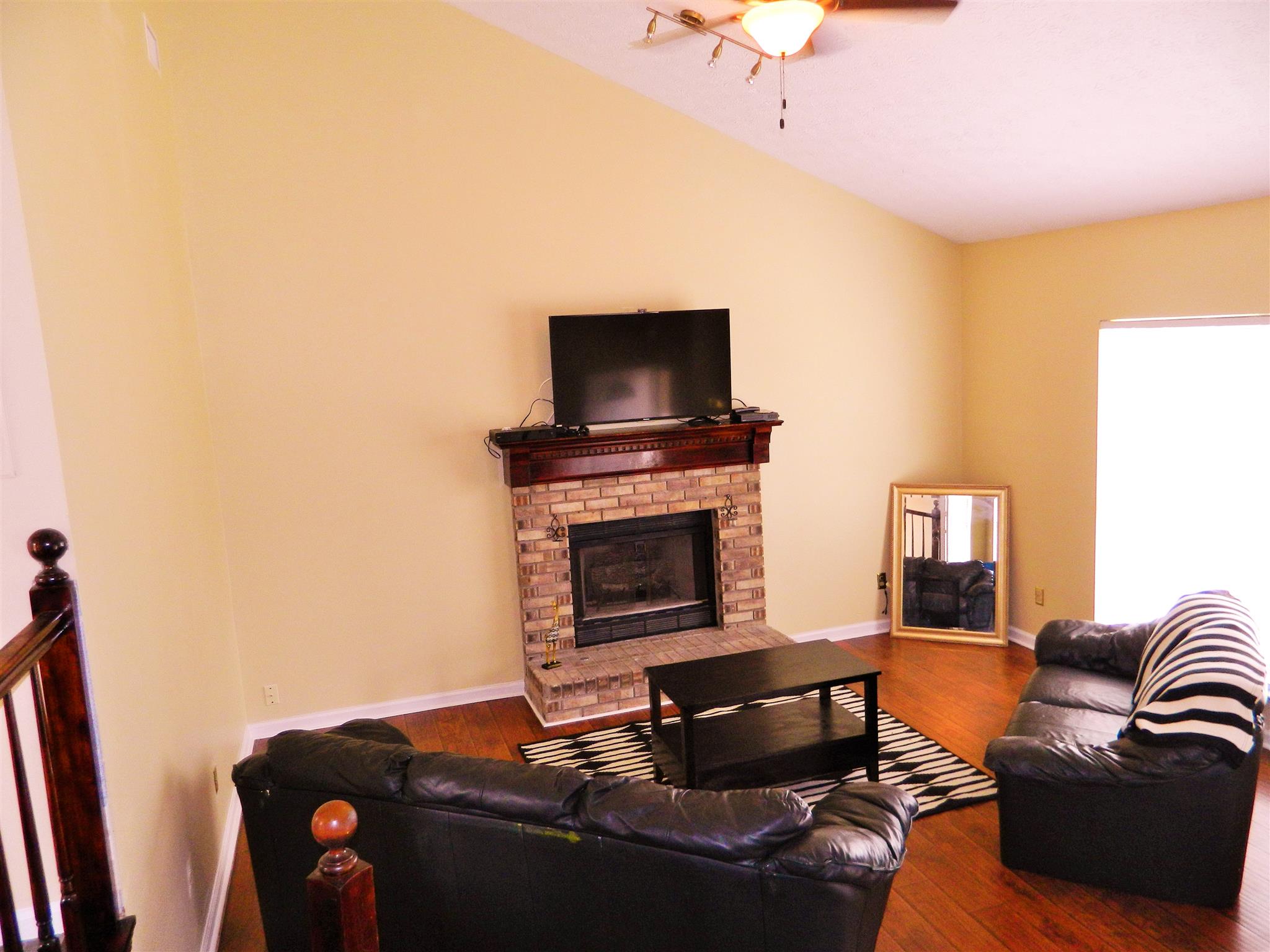 881 Bishopsgate Road Antioch, TN 37013 - Photo 2 of 19 a living room with furniture and a fireplace