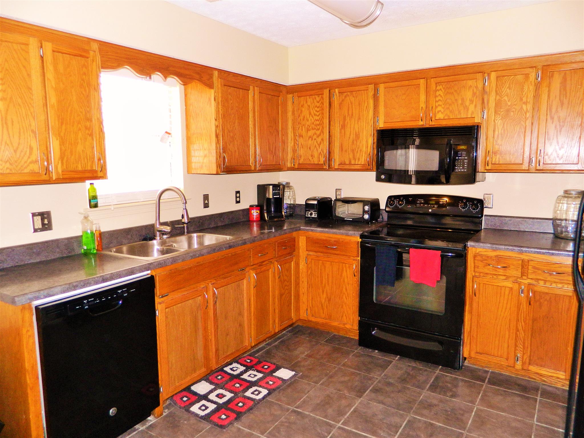 881 Bishopsgate Road Antioch, TN 37013 - Photo 6 of 19 a kitchen with stainless steel appliances a stove a sink dishwasher and a microwave oven with cabinets