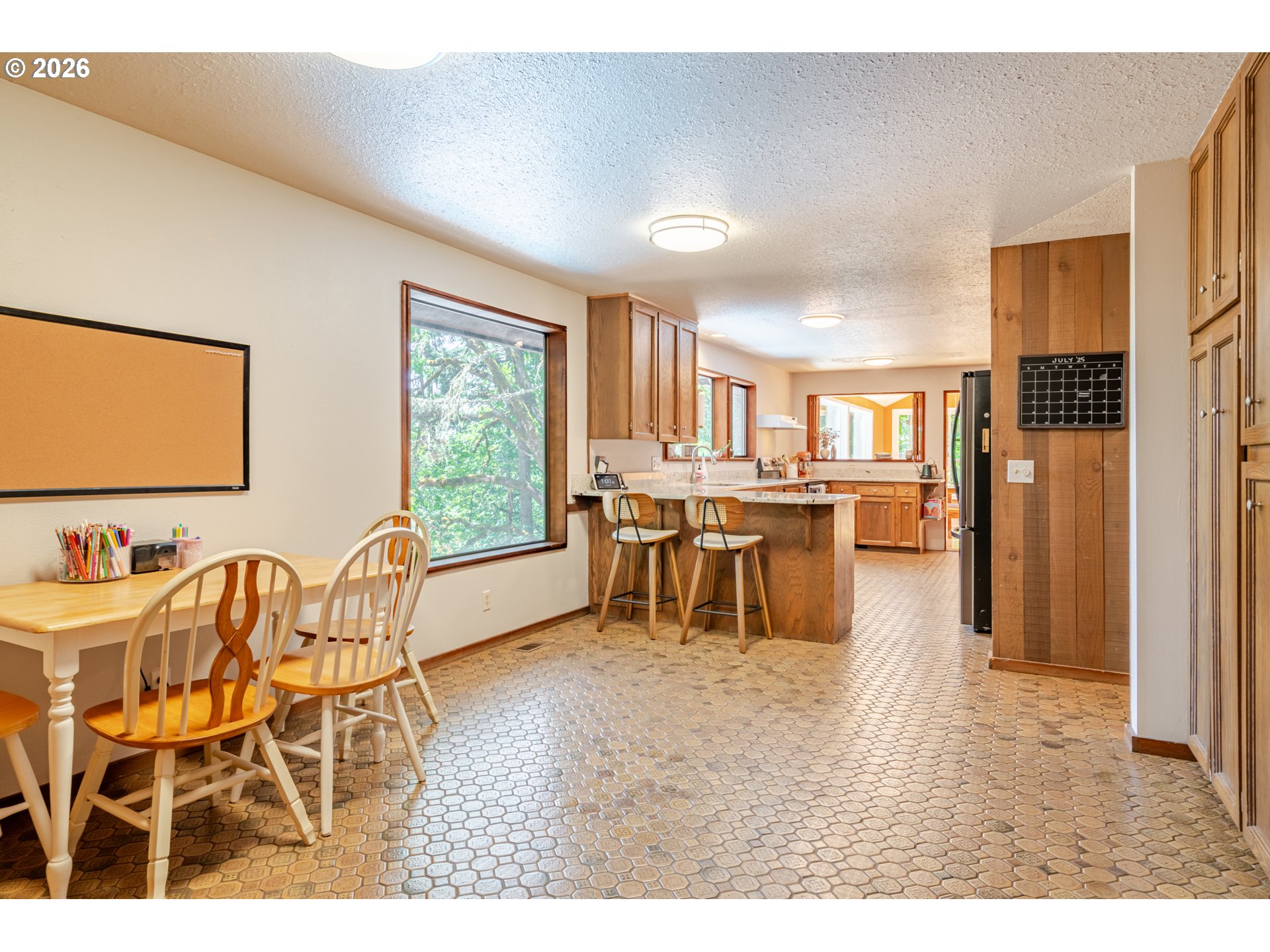 1622 Northwest Ribier Place Corvallis, OR 97330 - Photo 16 of 48 a dining hall with stainless steel appliances kitchen island granite countertop a refrigerator a stove a sink dishwasher with a dining table and chairs