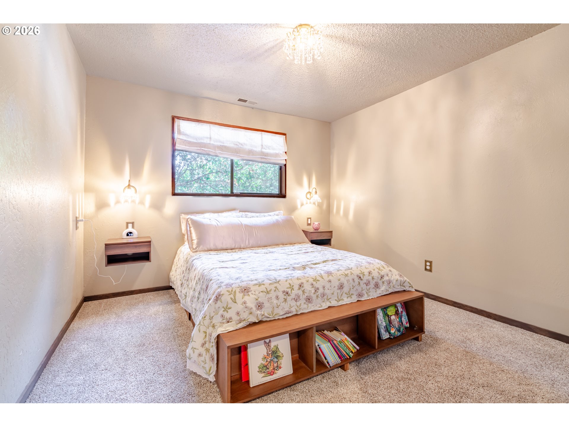1622 Northwest Ribier Place Corvallis, OR 97330 - Photo 28 of 48 a spacious bedroom with a bed and a chandelier