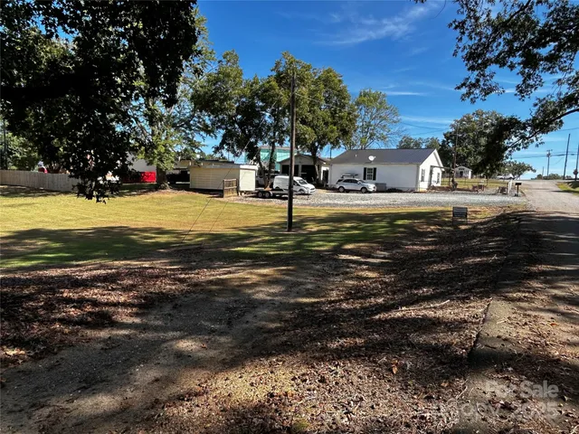 a kitchen with a dining table cabinets appliances and a window