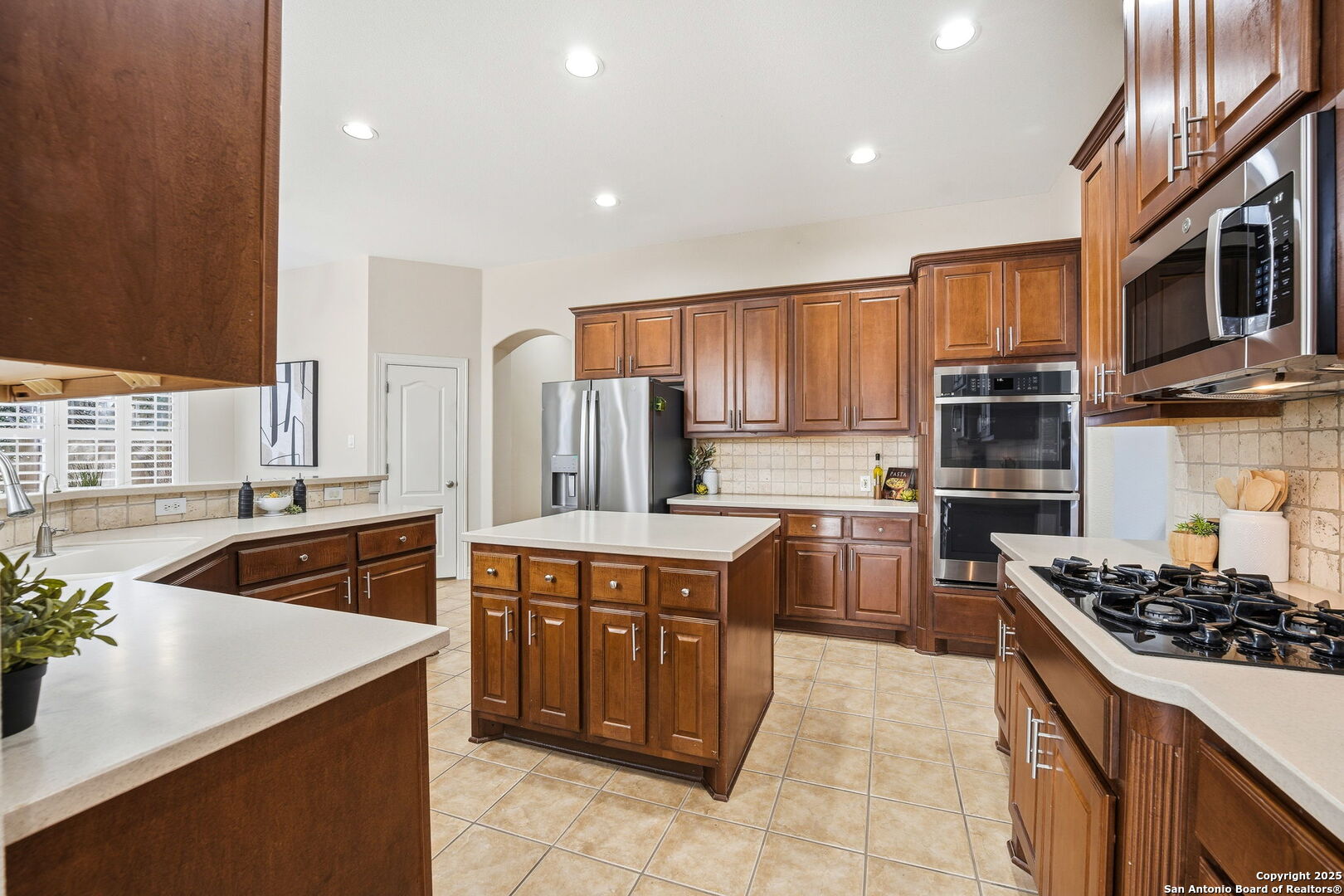 410 Heather Ridge San Antonio, TX 78260 - Photo 16 of 43 a kitchen with stainless steel appliances a stove sink and cabinets