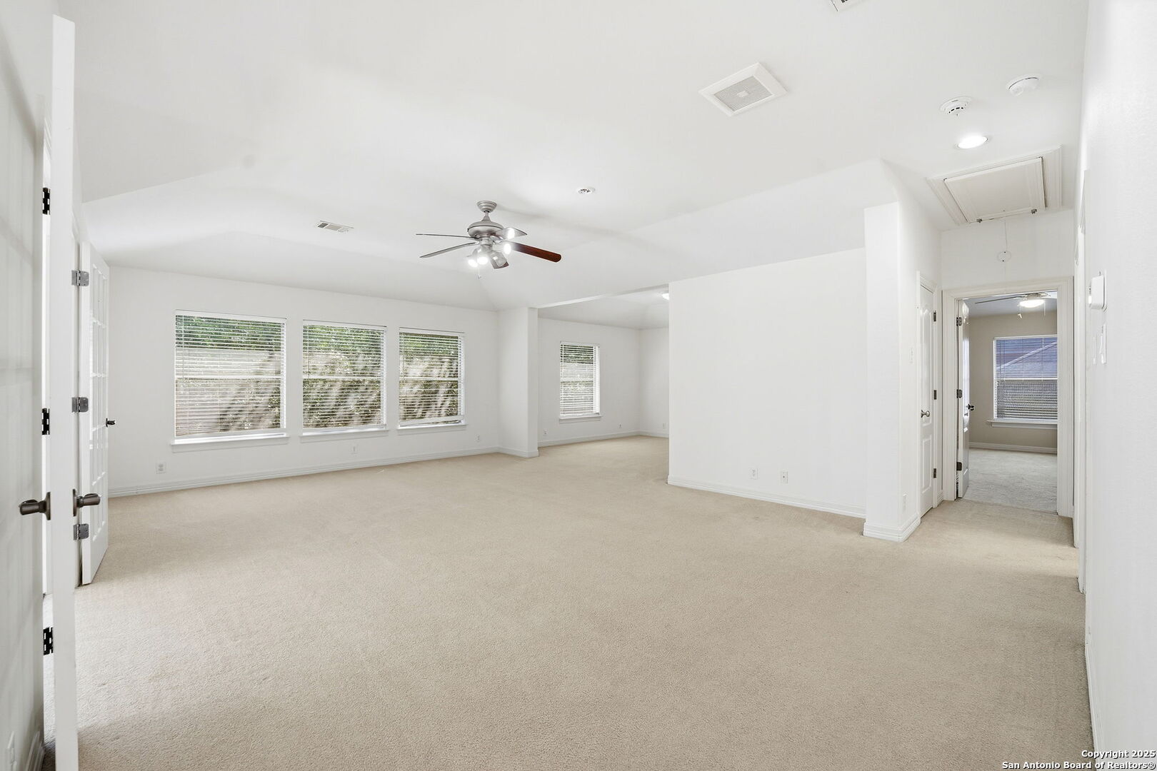 410 Heather Ridge San Antonio, TX 78260 - Photo 28 of 43 an empty room with windows and chandelier fan