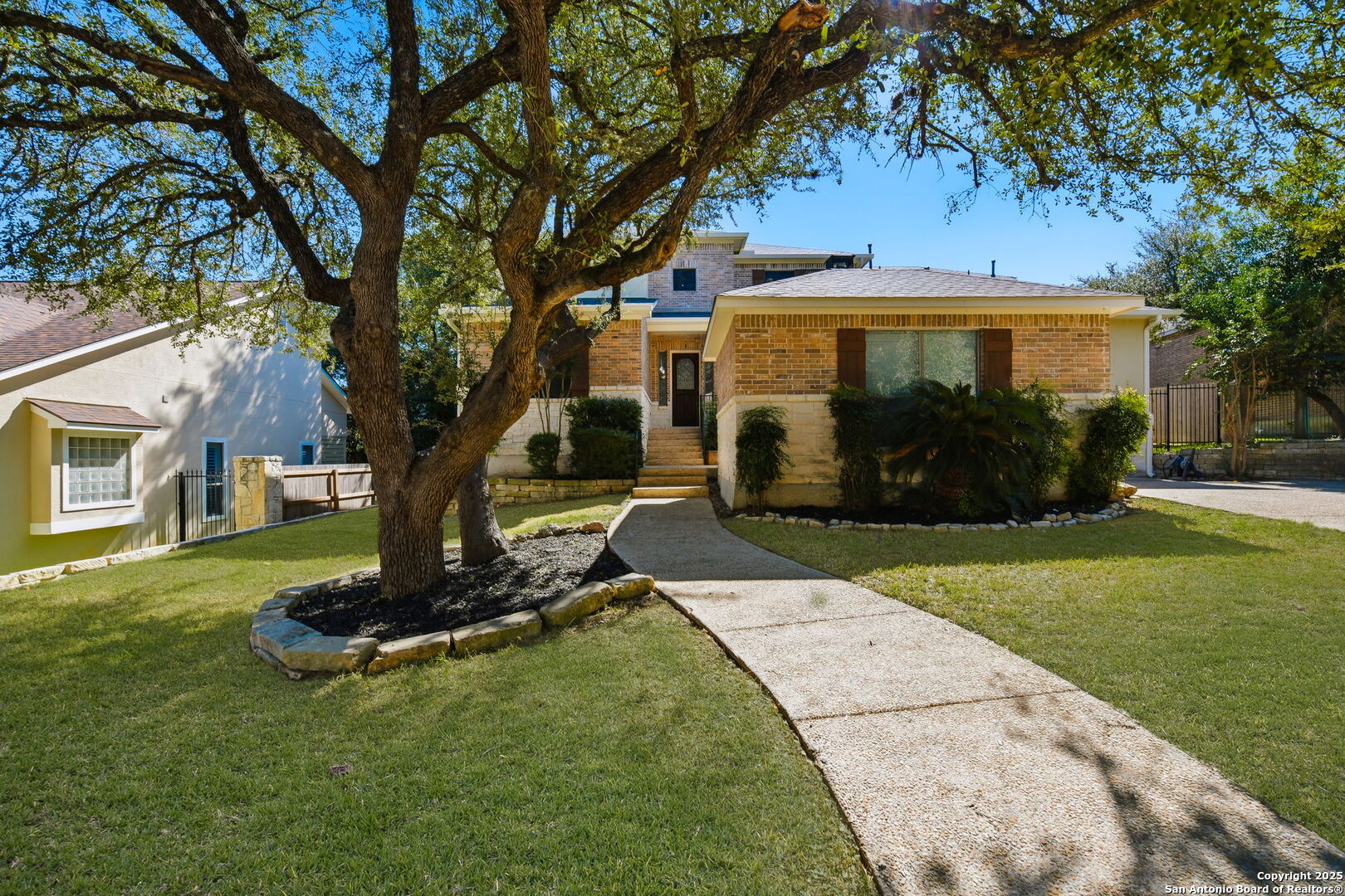 410 Heather Ridge San Antonio, TX 78260 - Photo 4 of 43 a front view of a house with a garden