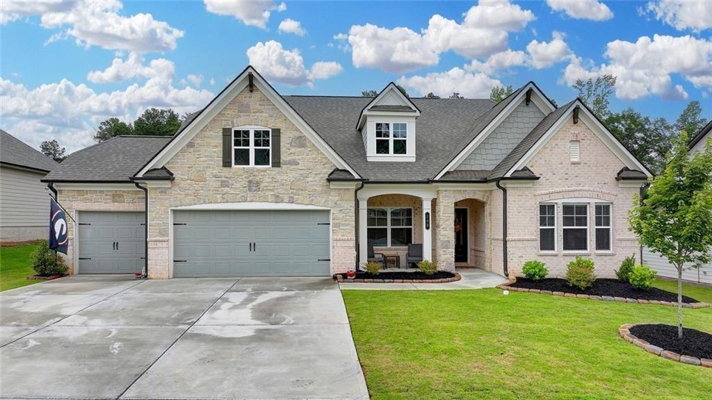 a front view of a house with garden