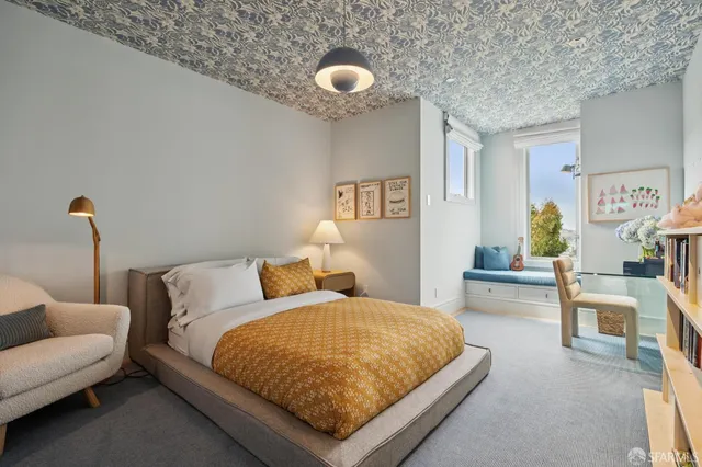 a bedroom with furniture and a window