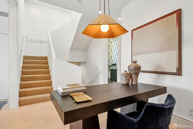 a bedroom with a bed and a couch next to a window