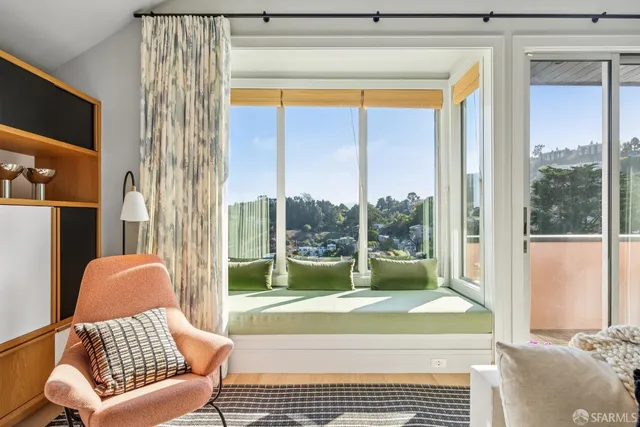 a living room with furniture and a piano