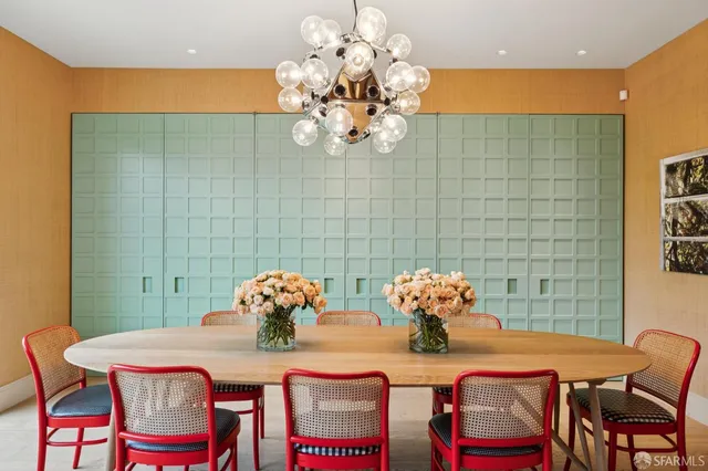 a dining room filled chandelier and wooden floor