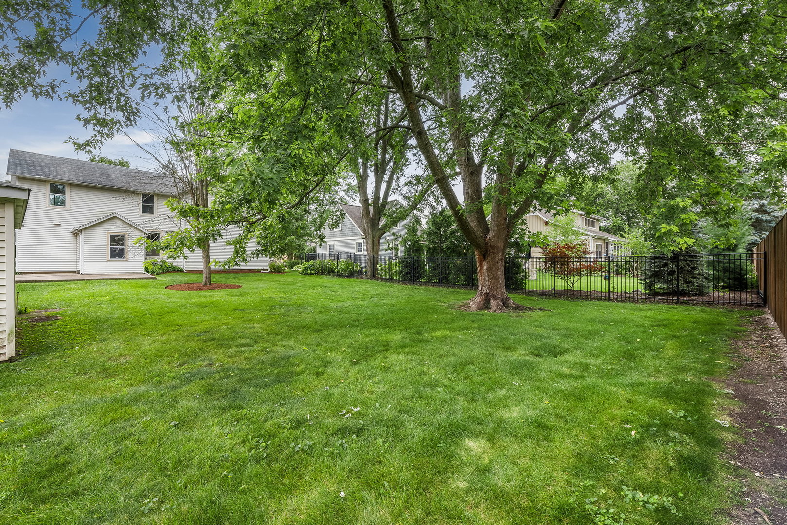 318 West Wing Street Arlington Heights, IL 60005 - Photo 15 of 16 a view of a white house with a big yard and large trees
