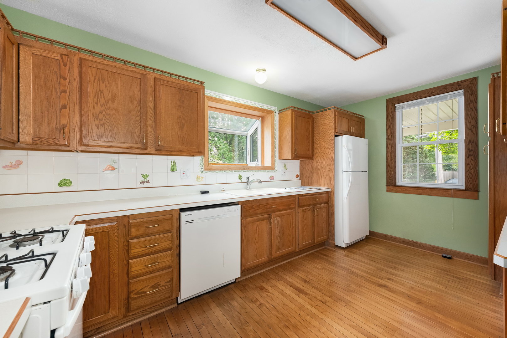318 West Wing Street Arlington Heights, IL 60005 - Photo 6 of 16 a kitchen with sink cabinets and window