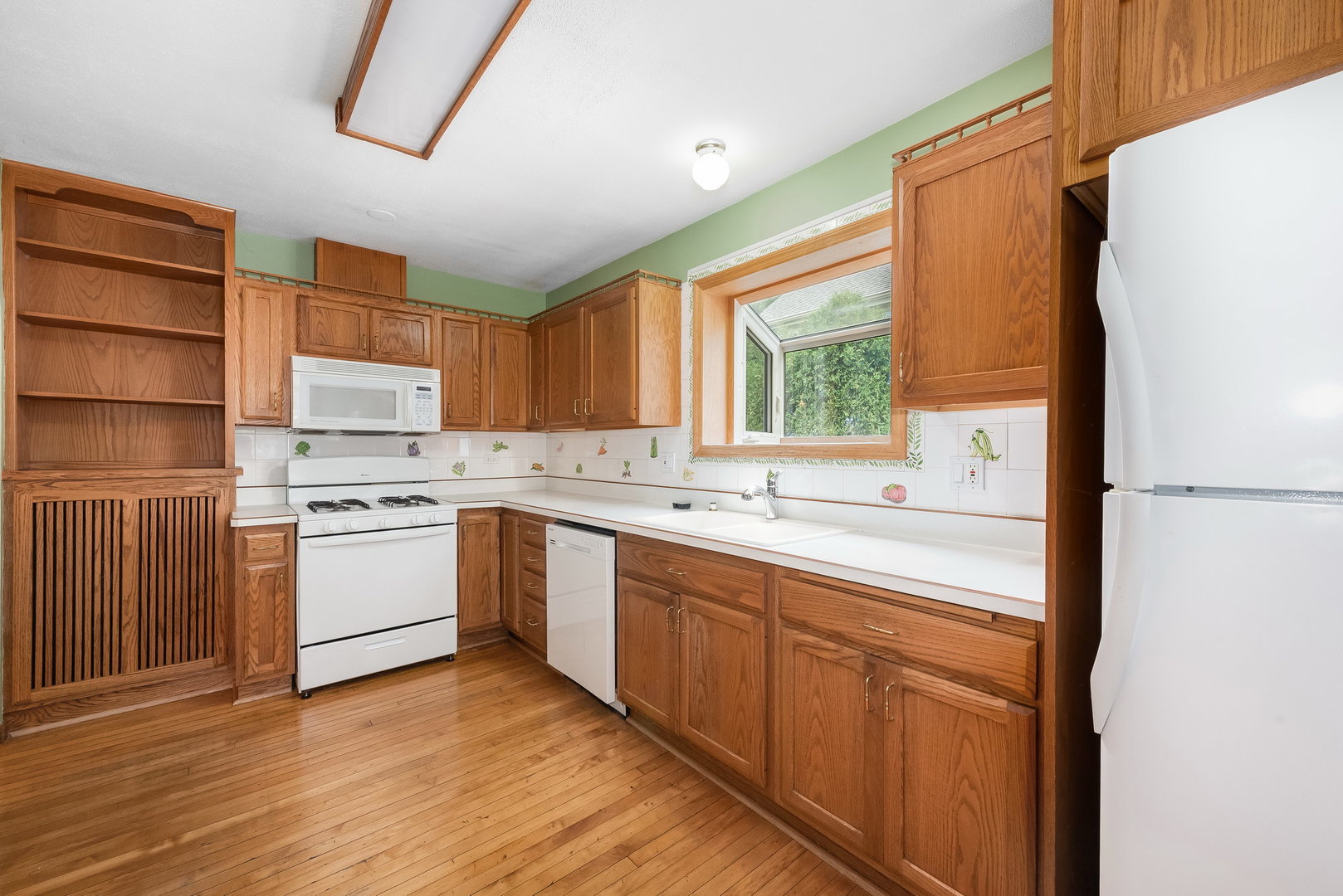 318 West Wing Street Arlington Heights, IL 60005 - Photo 7 of 16 a kitchen with a sink cabinets stainless steel appliances and a window