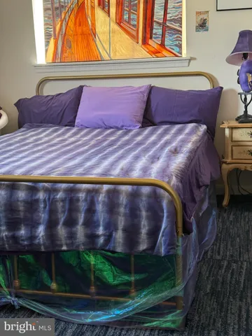 a bed sitting in a bedroom next to a window