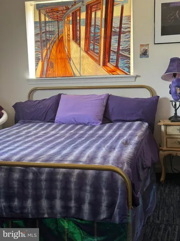 a bedroom with a bed window and couch