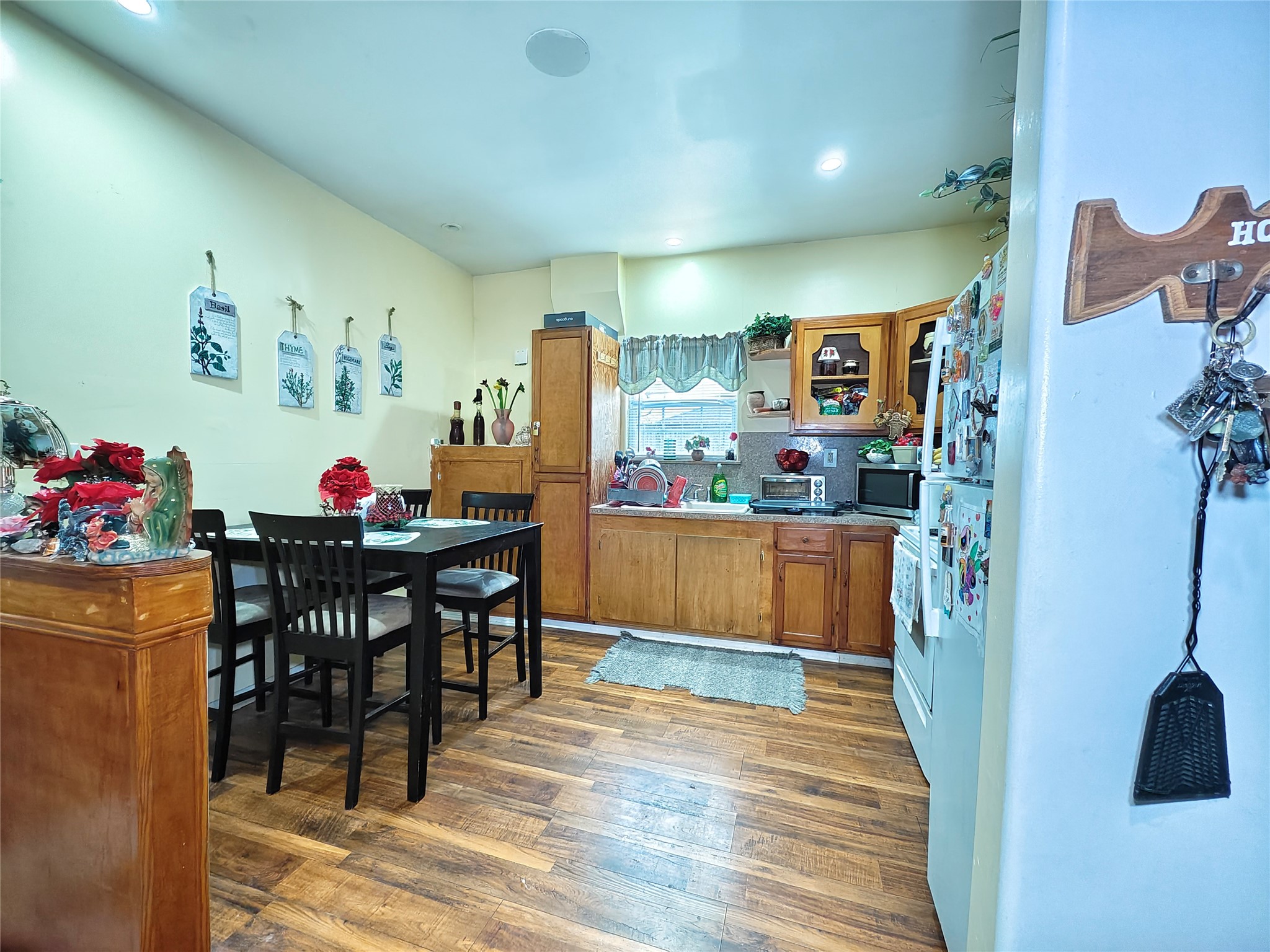 7931 Scanlock Street Houston, TX 77012 - Photo 23 of 28 a view of a dining room with furniture and wooden floor