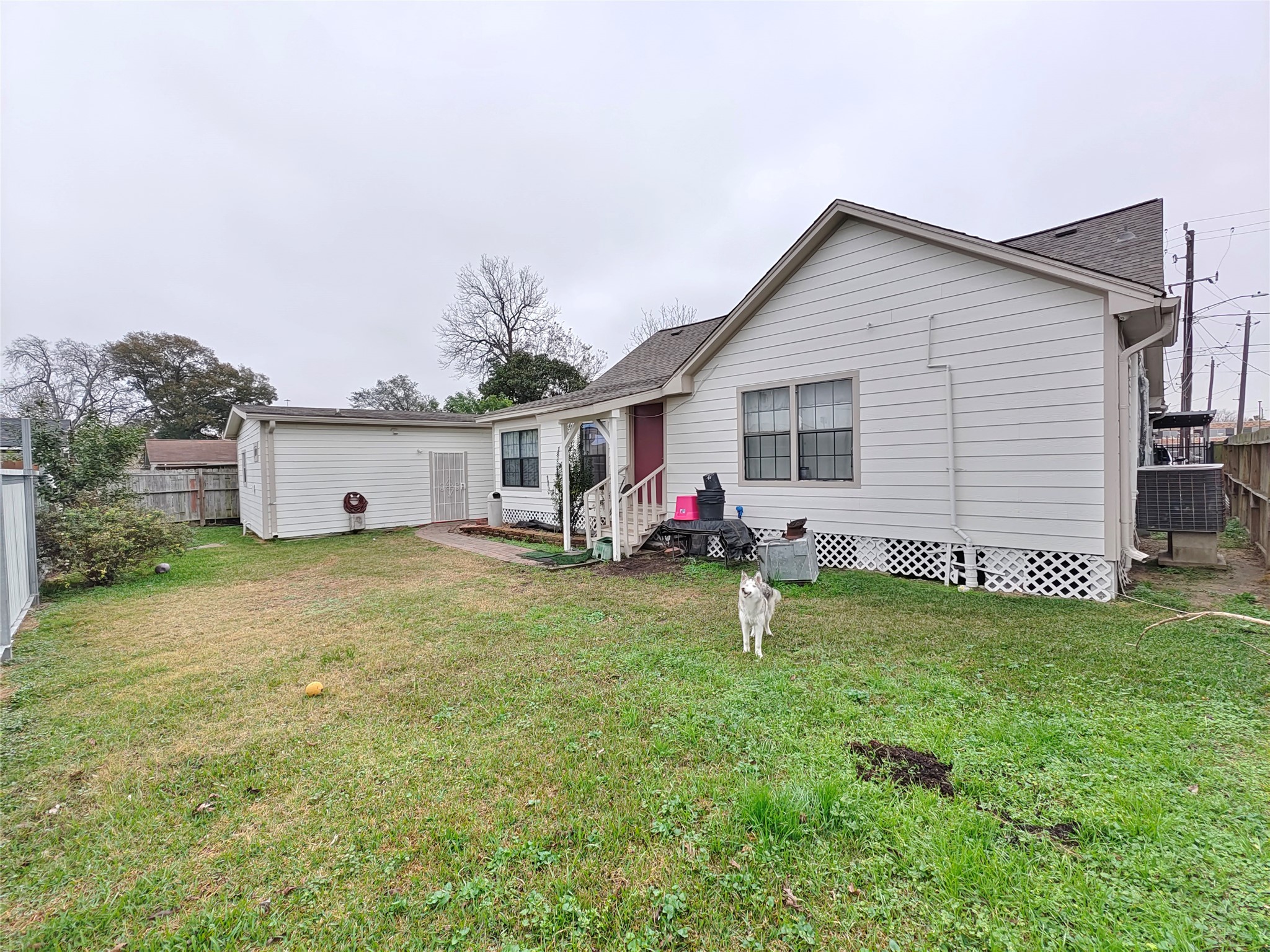 7931 Scanlock Street Houston, TX 77012 - Photo 28 of 28 a view of a house with backyard and a tree