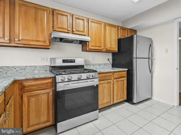 a kitchen with granite countertop cabinets stainless steel appliances and a sink