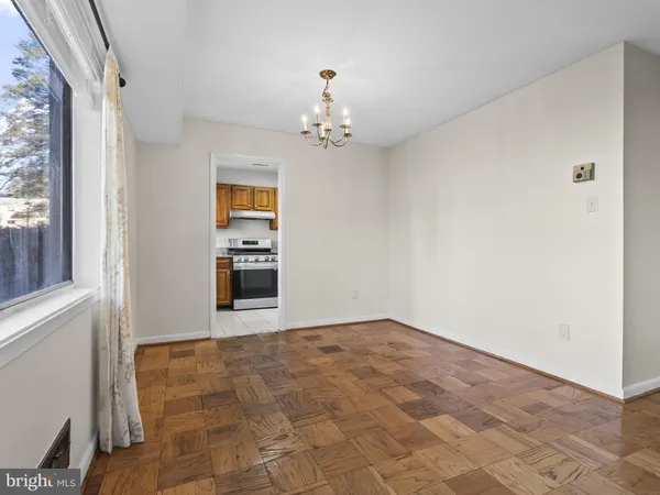 a view of a kitchen with an empty space and a window