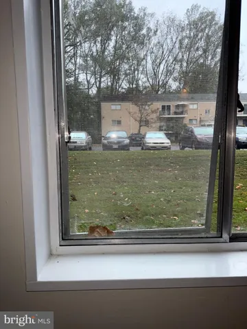 a view of a wooden door and a window