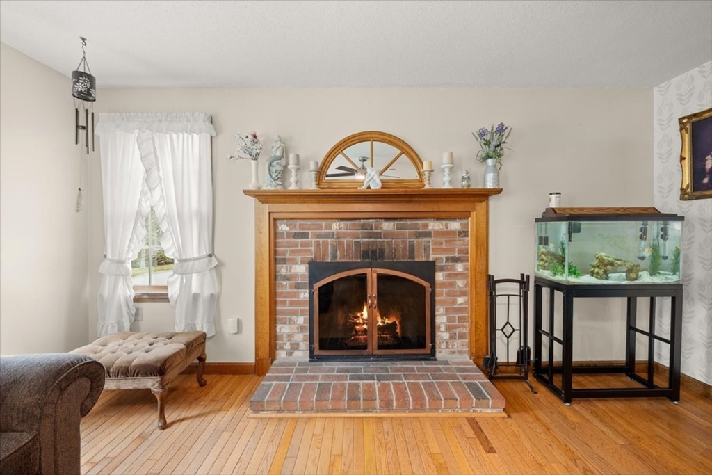 34 Windsor Way Mashpee, MA 02649 - Photo 20 of 42 a living room with furniture and a fireplace