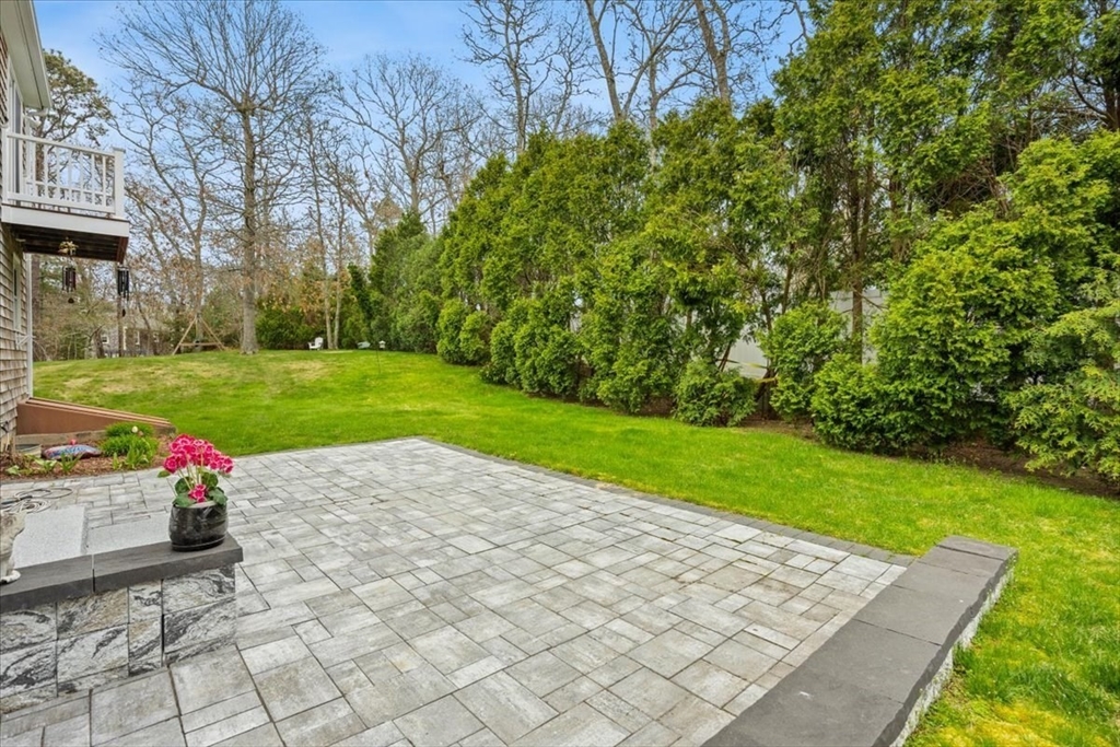 34 Windsor Way Mashpee, MA 02649 - Photo 6 of 42 a white house with a yard and plants