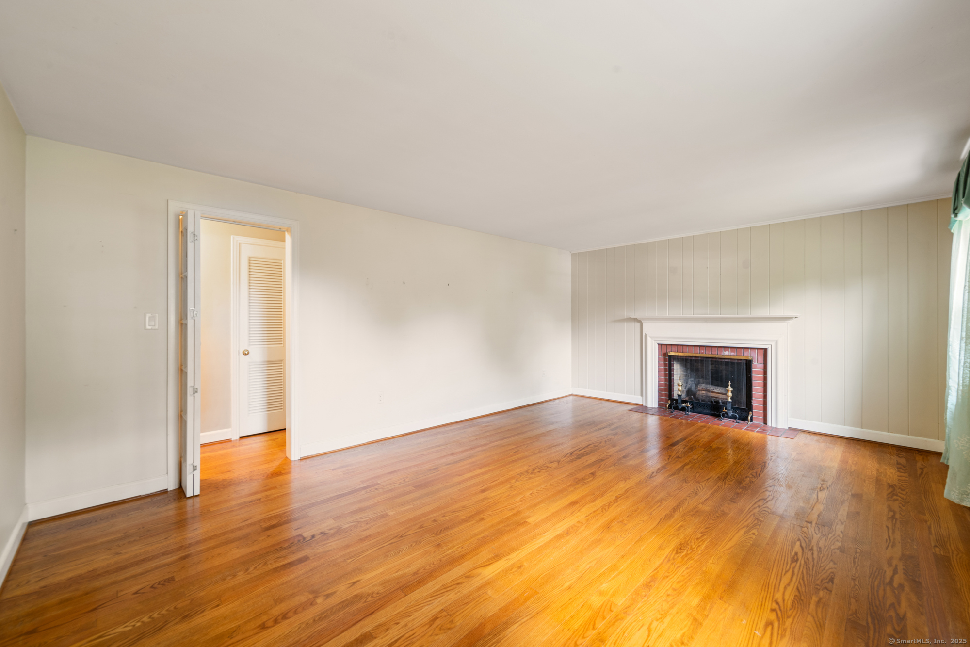 80 Dryden Drive Meriden, CT 06450 - Photo 9 of 23 a view of an empty room with wooden floor fireplace and a window