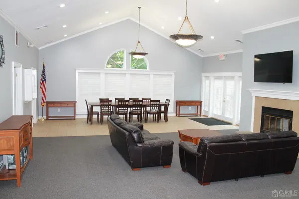 a living room with furniture fireplace and flat screen tv