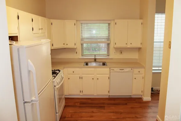 a view of a kitchen with wooden floor