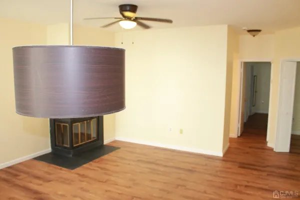 a view of kitchen and hall with wooden floor